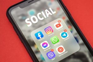 Social Media Updates That Could Affect Your B2B Strategy – June 2023 Round Up Picture of iPhone displaying social apps