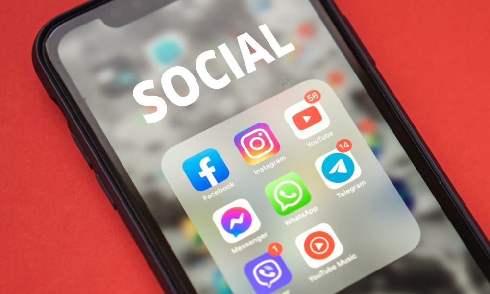 Social Media Updates That Could Affect Your B2B Strategy – June 2023 Round Up Picture of iPhone displaying social apps